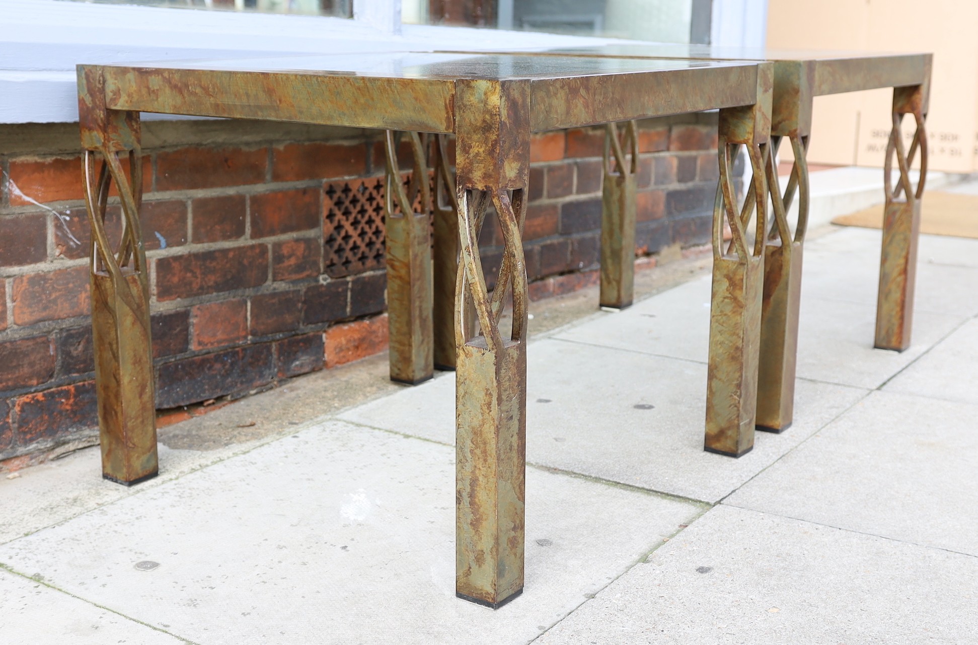 A pair of contemporary bronze metal and glass occasional tables, width 60cm. height 51cm